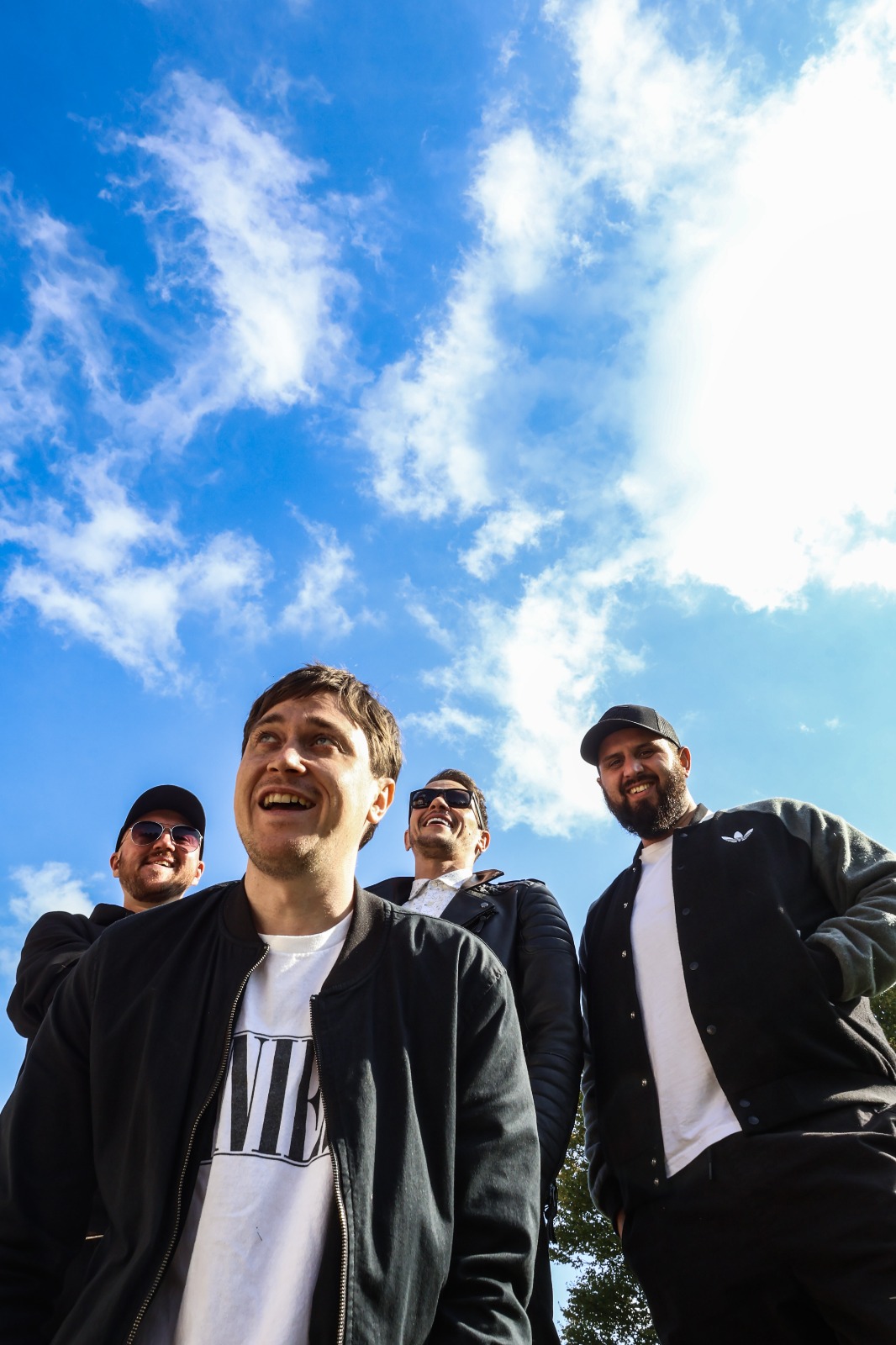 32tens Image of 32tens band members in front of a blue sky